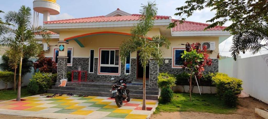 a motorcycle parked in front of a house at GTR Royal Palace cottage in Wodapatti