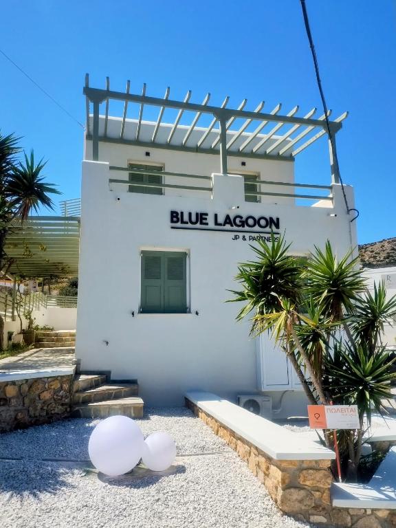 a white building with a blue lagoon sign on it at Βlue Lagoon G6 in Galissas