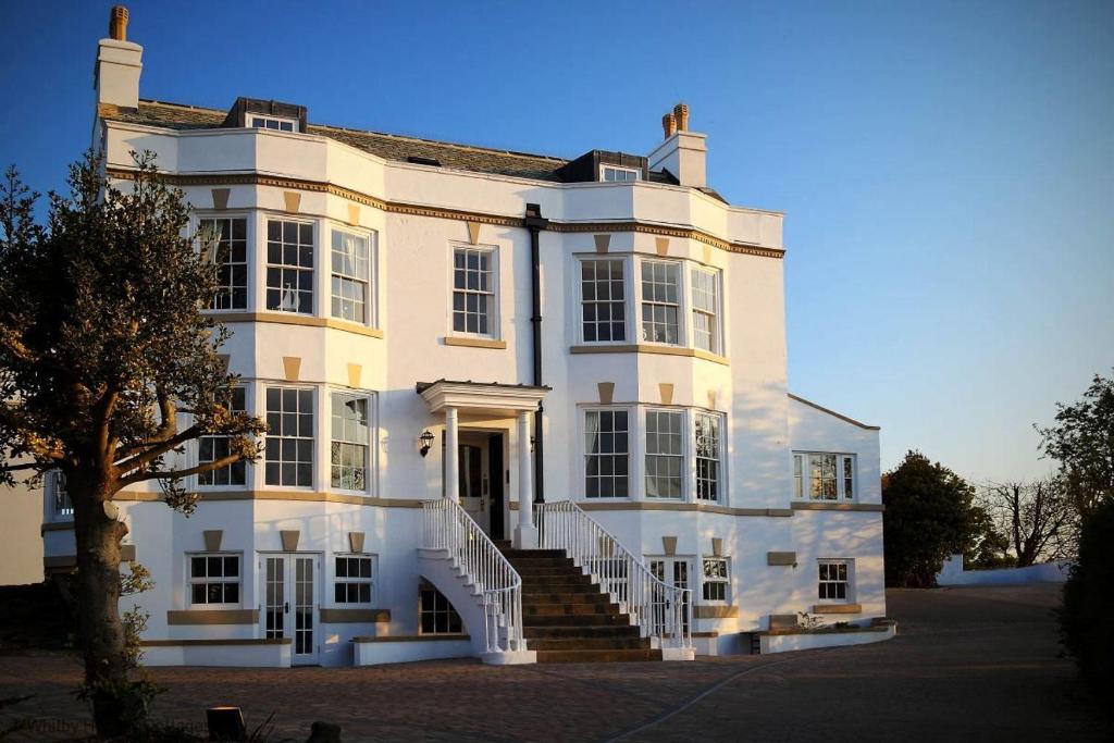 a large white house with stairs in front of it at Spinnaker, Whitehall in Ardeonaig