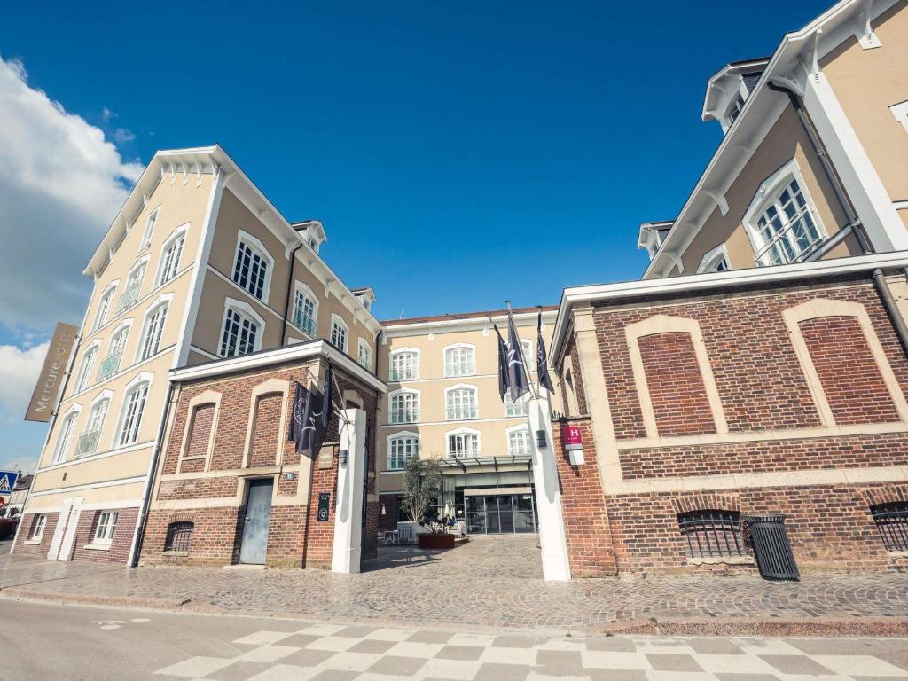 a large brick building on the side of a street at Mercure Troyes Centre in Troyes