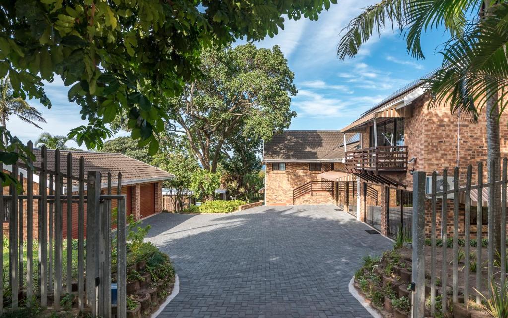 a driveway leading to a house with a gate at The 3rd Leg Bed and Breakfast in Pennington