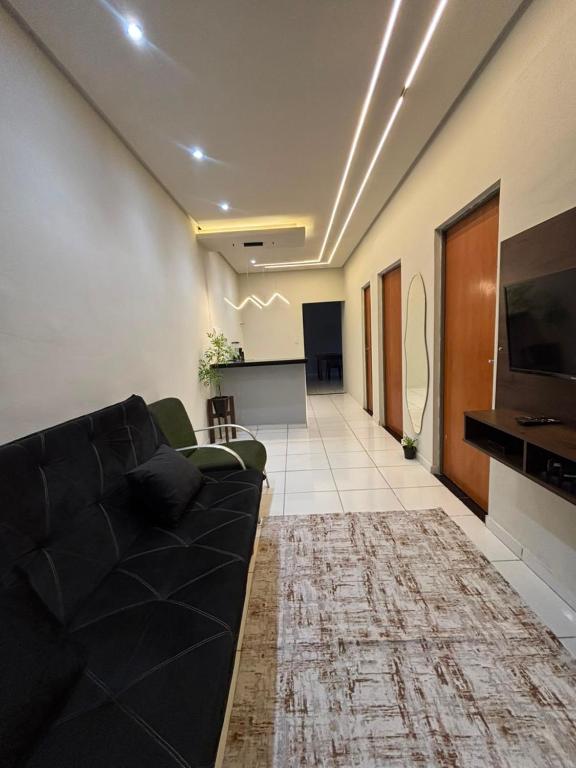 a living room with a couch and a flat screen tv at RODRIGUES CASA de TEMPORADA em Barreirinhas in Barreirinhas
