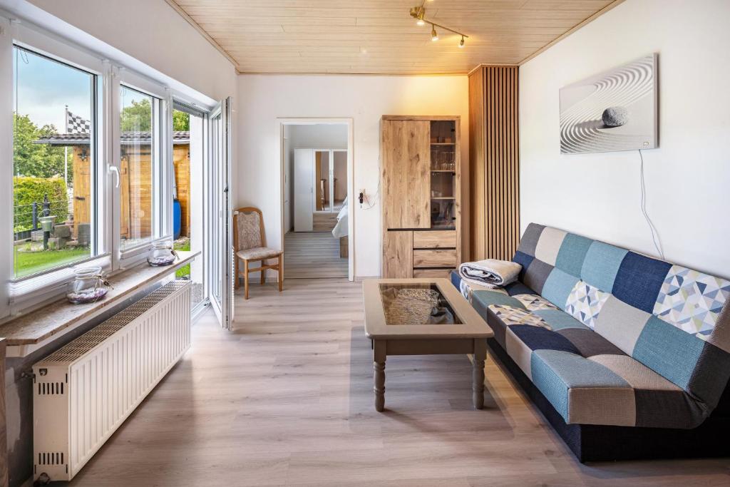 a living room with a couch and a table at Fewo zum Eisenstollen in Balve