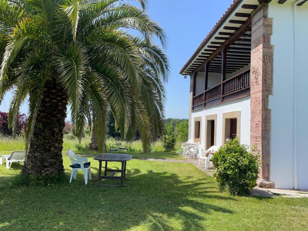 a table and a palm tree next to a building at R2R - Finca Ranapega - 34A03 in Escamprero