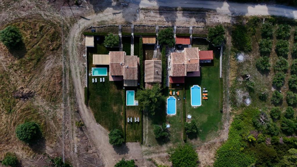 an aerial view of a yard with houses at Stone Made Private Pool Villas Kriopigi in Kriopigi