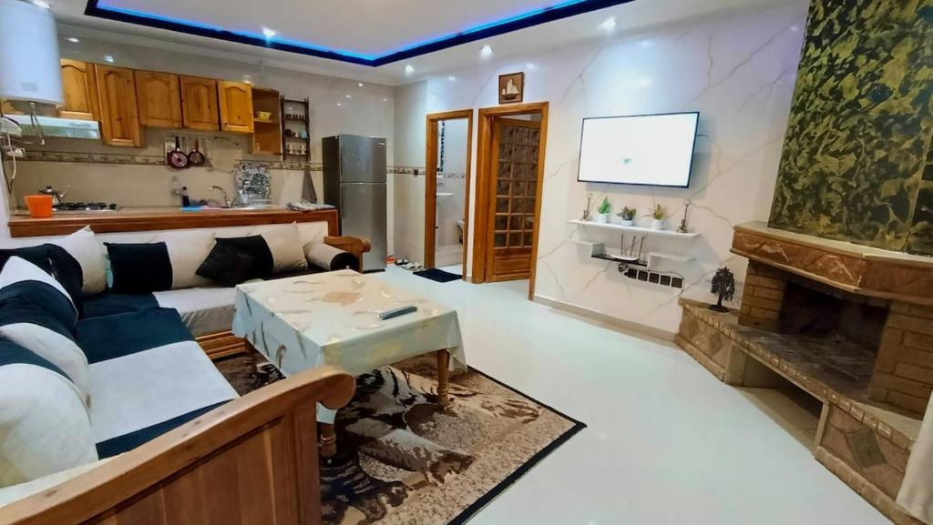 a living room with a couch and a fireplace at Cozy Central Studio in Ifrane in Ifrane