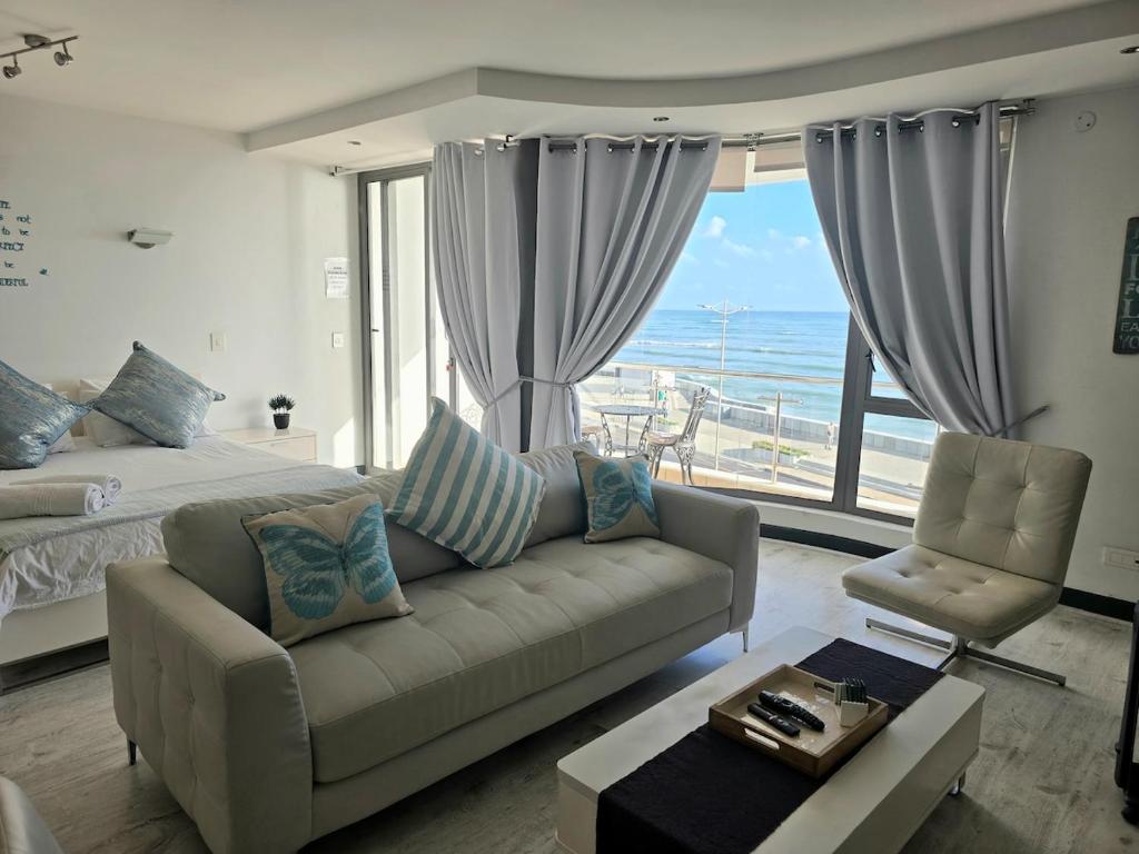 a living room with a couch and a large window at Hibernian Towers 307 in Strand