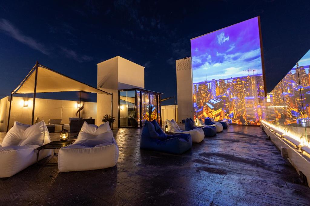 a large room with couches and a large screen at Giverny Hotel in Gyeongju