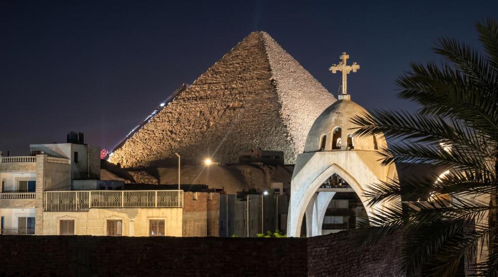 a church with a cross on top of a pyramid at Villa Golden Sunset Pyramids in Cairo