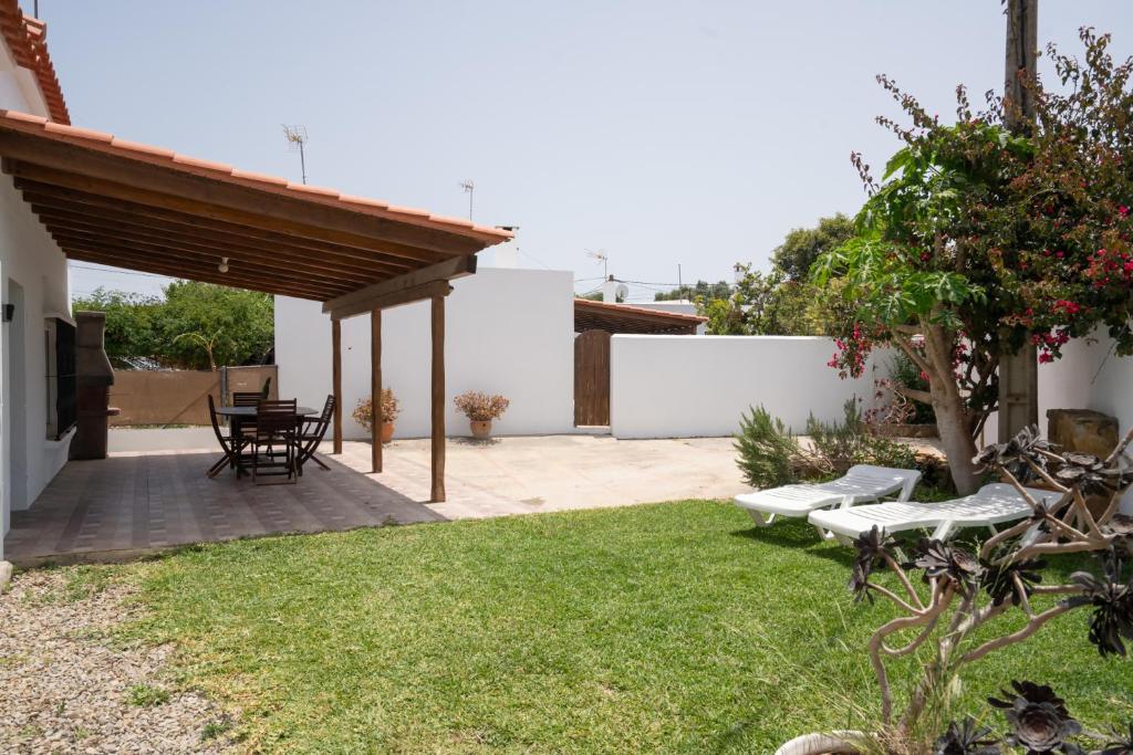 a patio with a table and chairs in a yard at La Huertina C2 in Zahora