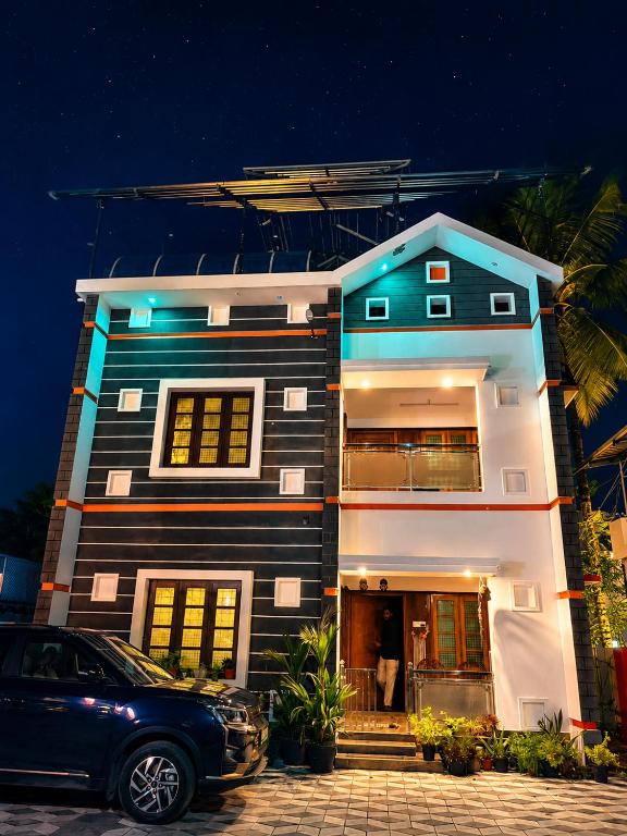 a house with a car parked in front of it at Phoenix homestay in Varkala