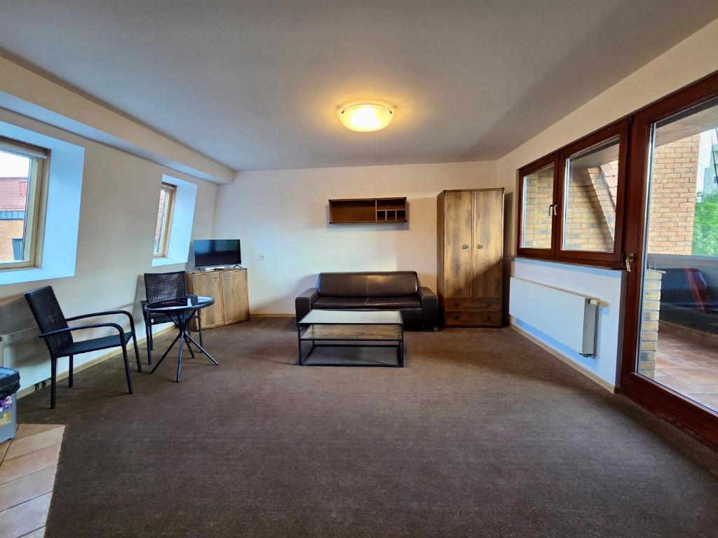 a living room with a couch and a table at Justinrent Szpitalna 4D-5 in Legnica