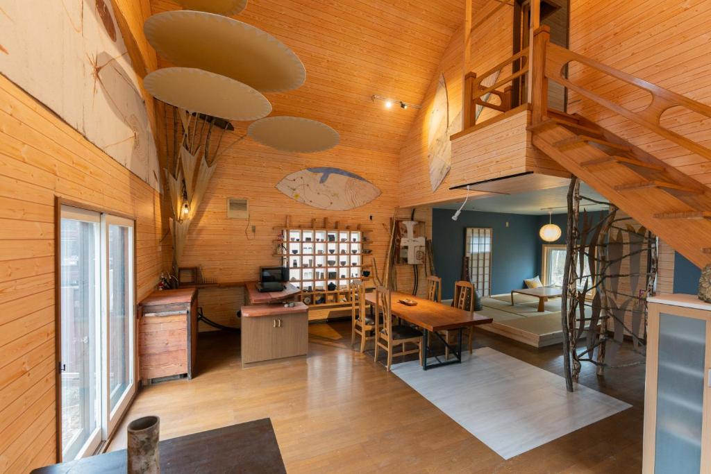 a room with a wooden ceiling with a loft at Kussharoko Artemina Lotus in Teshikaga