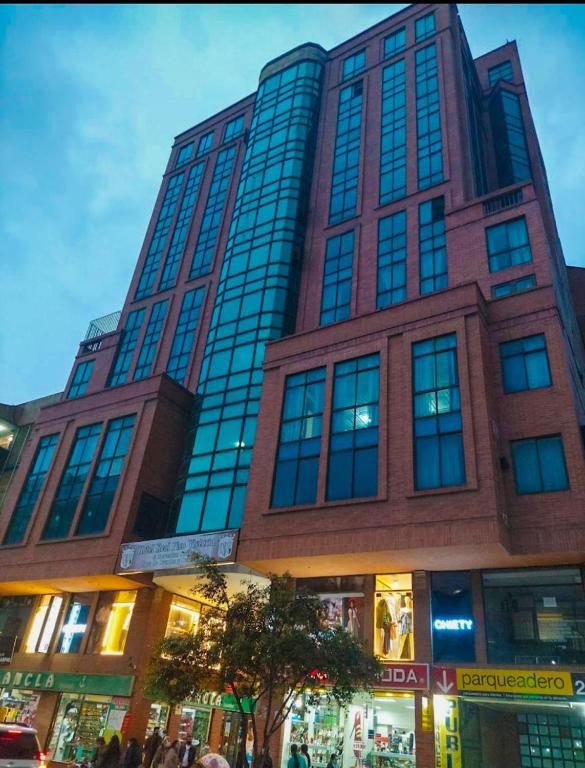 a tall building with people standing in front of it at HOTEL REALPICO VICTORIA in Duitama