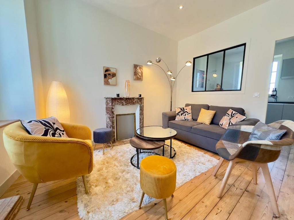 a living room with a couch and a table at Le Quai Granvillais in Granville