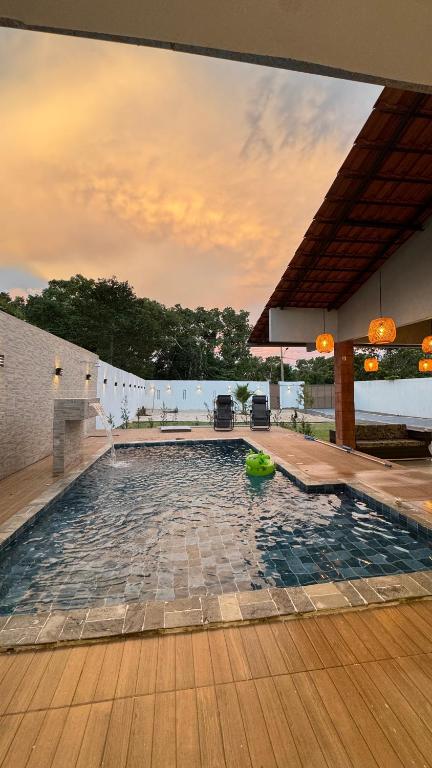 a swimming pool in the middle of a house at Chácara encantos Iranduba in Iranduba