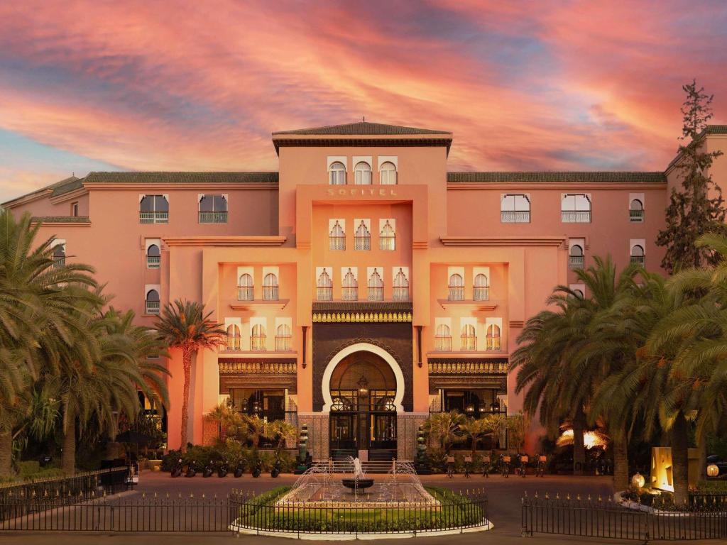 a large building with a fountain in front of it at Sofitel Marrakech Palais Impérial & Spa in Marrakesh