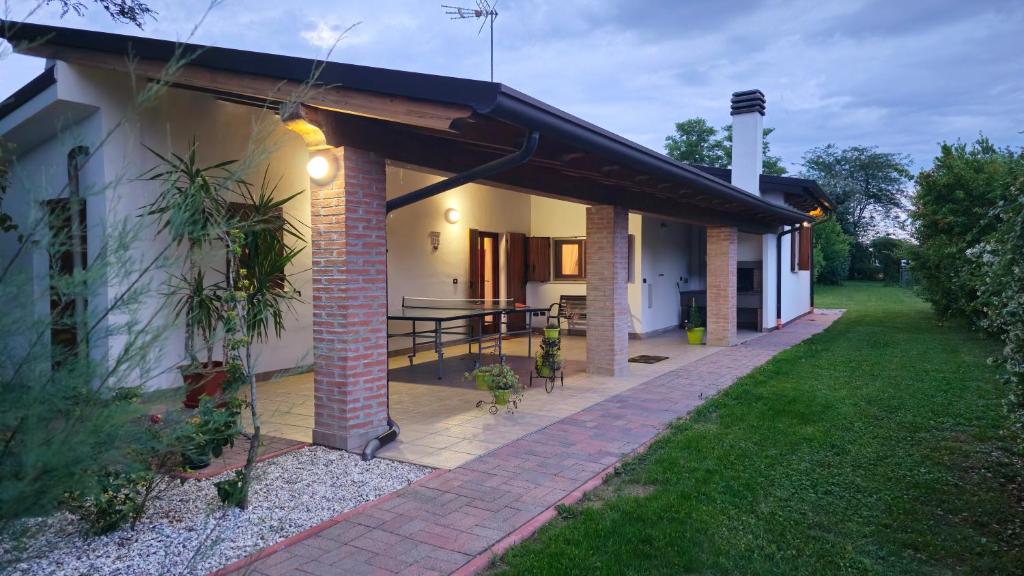 a house with a patio with a table on it at LUCIA s sweet Home in Padova