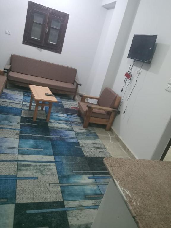 a living room with a couch and a table at العلمين هوسيز in El Alamein