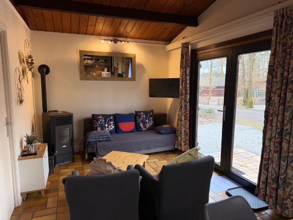 a living room with a couch and a table at Cabana 16 in Petit Mesnil