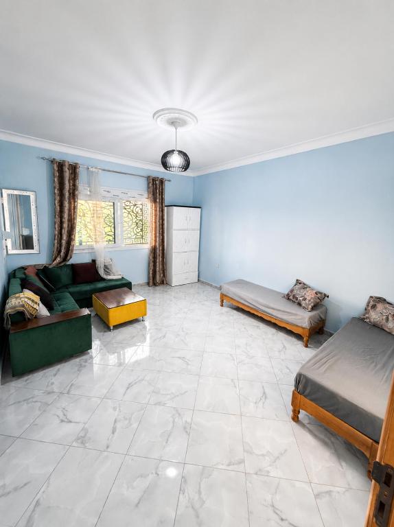 a living room with two beds and a couch at Azure Coast Residence in Mostaganem