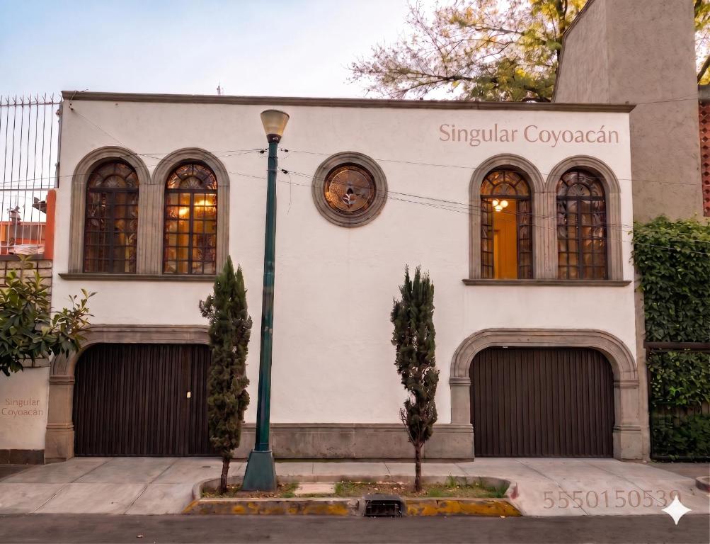 a building with two garage doors and a street light at Singular Coyoacán Pepper My Love! in Mexico City