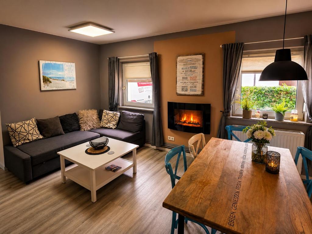 a living room with a couch and a table at Ferienwohnungen Stilschön in Warnemünde