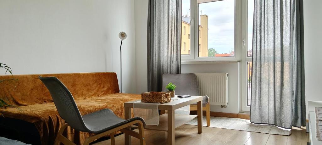 a living room with a couch and a table at Przystań Kamień Centrum in Kamień Pomorski