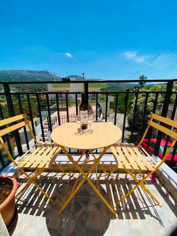 a table and two chairs on a balcony at Plativola Mountain View in Sitia