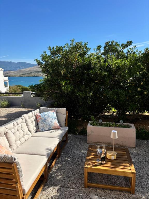 a patio with a couch and a coffee table at ThePAGHouse in Pag