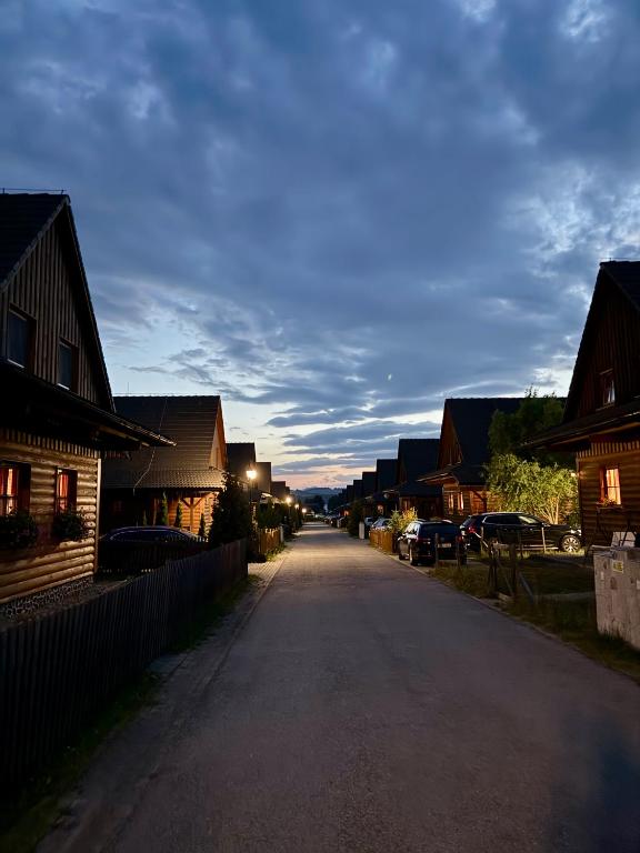 an empty street in a town with wooden houses at Liptovské Chaty in Liptovský Mikuláš