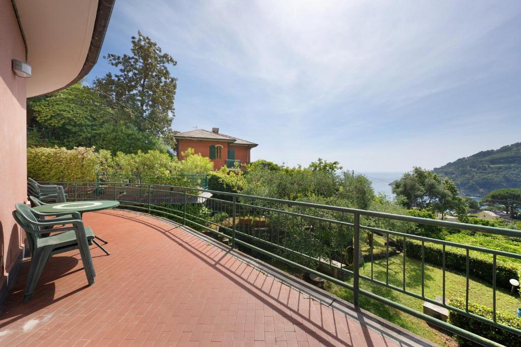 a balcony of a house with a table and chairs at Casa alta lucio in Bonassola