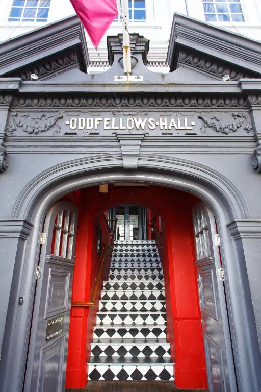 an entrance to a building with a red door and stairs at Oddfellows Chester Hotel & Apartments in Chester