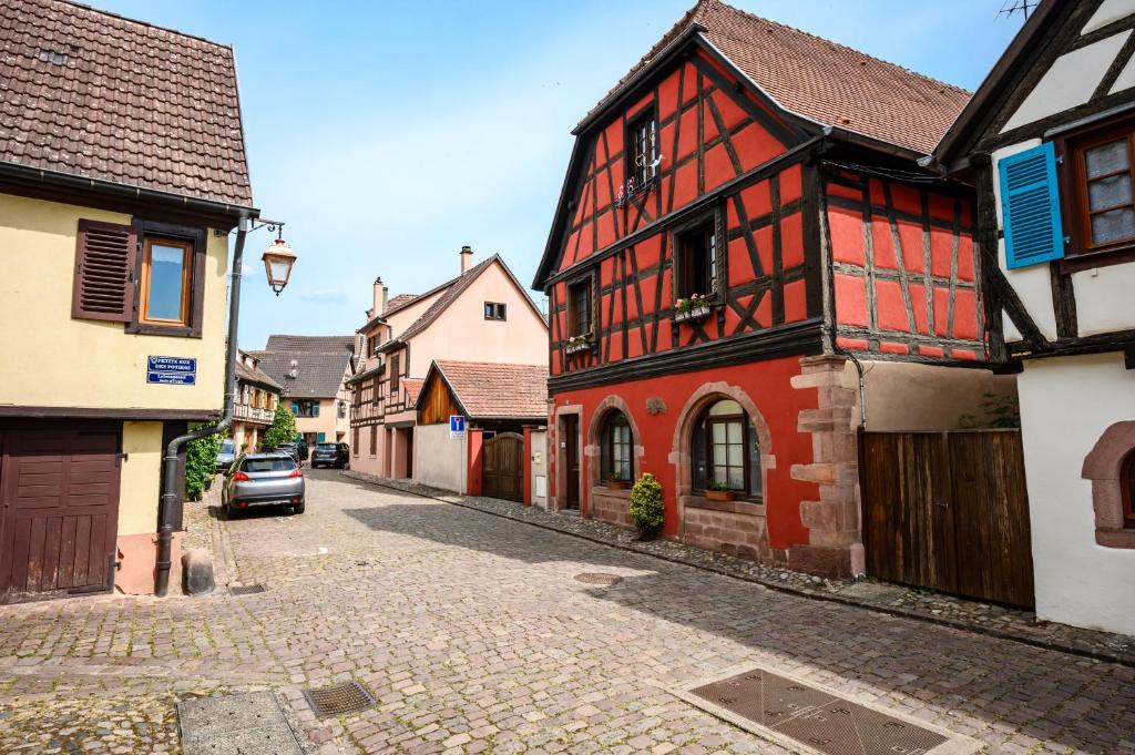 an alley in a medieval town with buildings at Gîte Le Nain Rouge in Kaysersberg