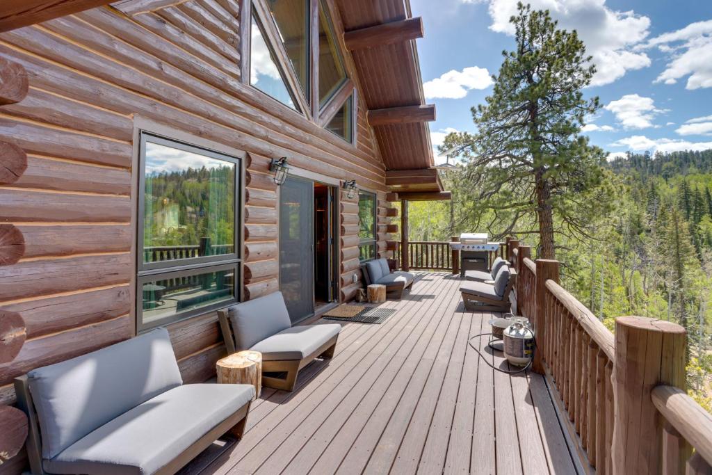 a deck with chairs and tables on a log cabin at Durango Mountain Escape w/ Stunning Views in Durango