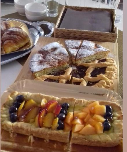 three boxes of different types of pastries on a table at La Principessa Nera B&B in Ostra