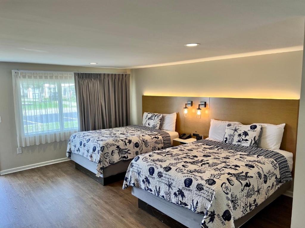 a hotel room with two beds and a window at Oceanview Inn - Emerald Isle in Emerald Isle