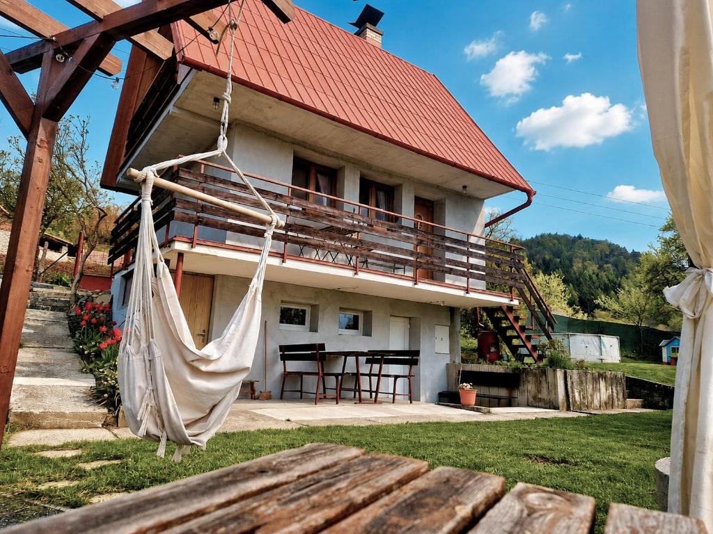 a house with a hammock in front of it at Chatička Lukov in Lukov