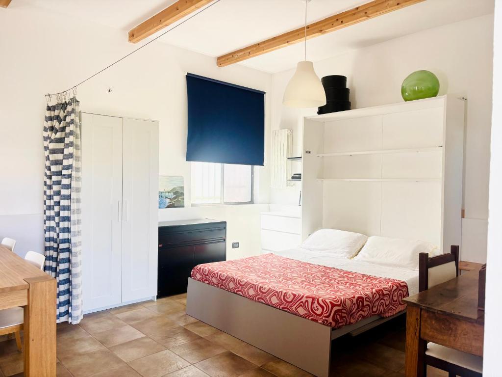 a bedroom with a bed in a room with a table at Casetta Rocca in Rocca San Giovanni