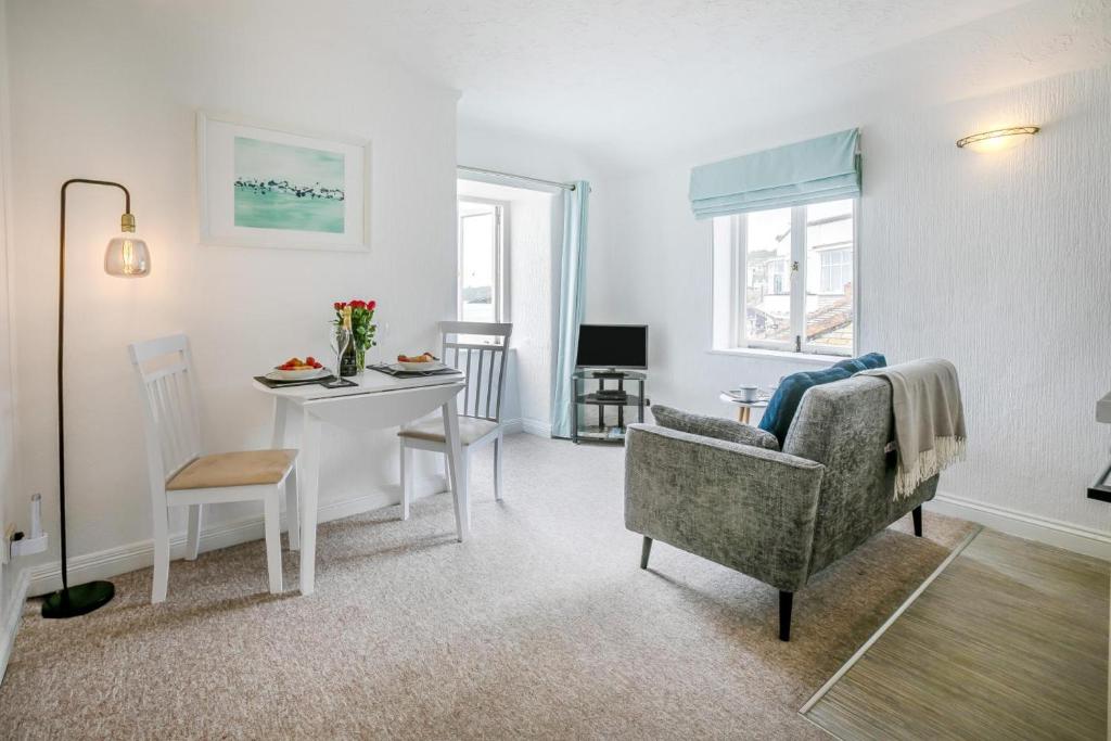 a living room with a table and a chair at 1 Bed in St. Ives oc-pc466a in St Ives