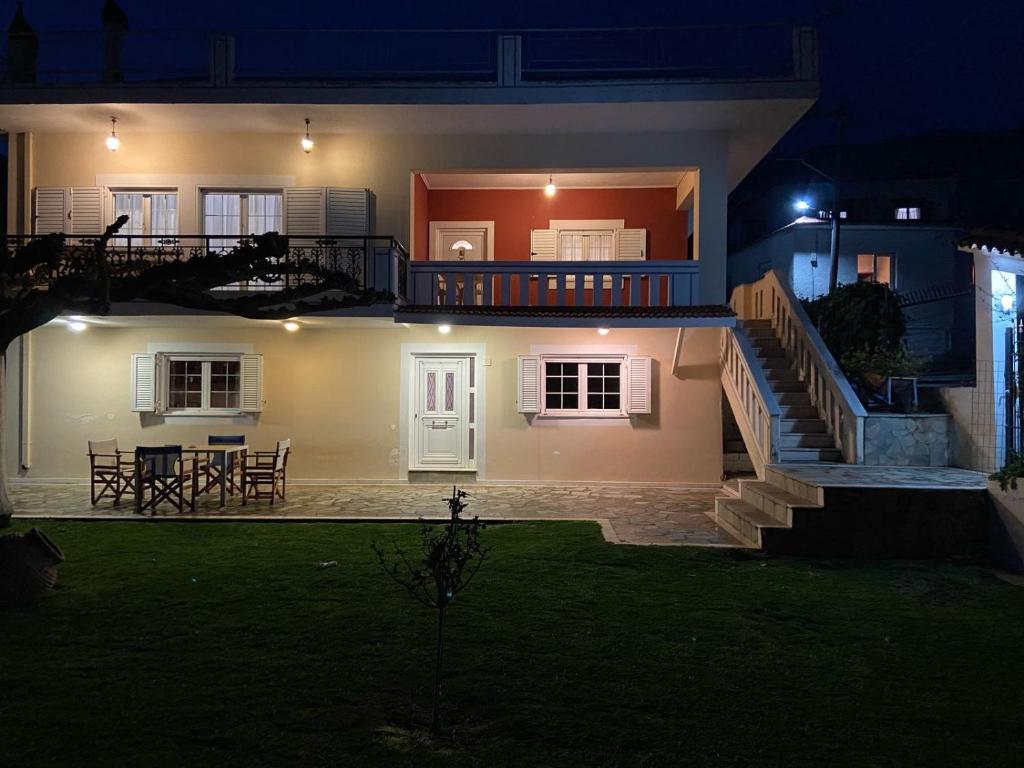 a large white house at night with a patio at Mytikas villa in Kandíla