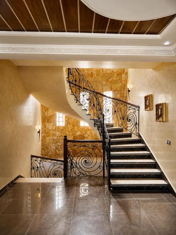 a spiral staircase in a building with a stone wall at Luxury Villa, 3 Levels, 5 bedrooms, 5 Baths, Pool & Garden in Tétouan