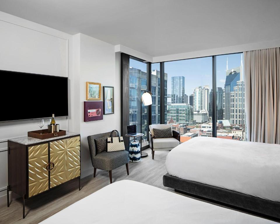 a hotel room with a bed and a flat screen tv at Hyatt Centric Downtown Nashville in Nashville