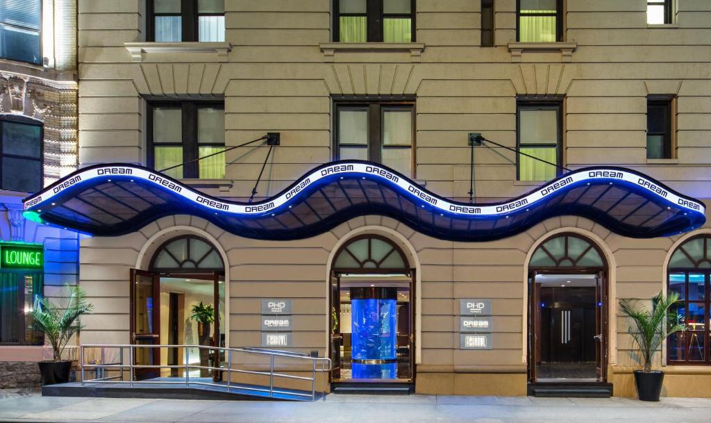 a building with a blue streak on it at Dream Midtown, by Hyatt in New York