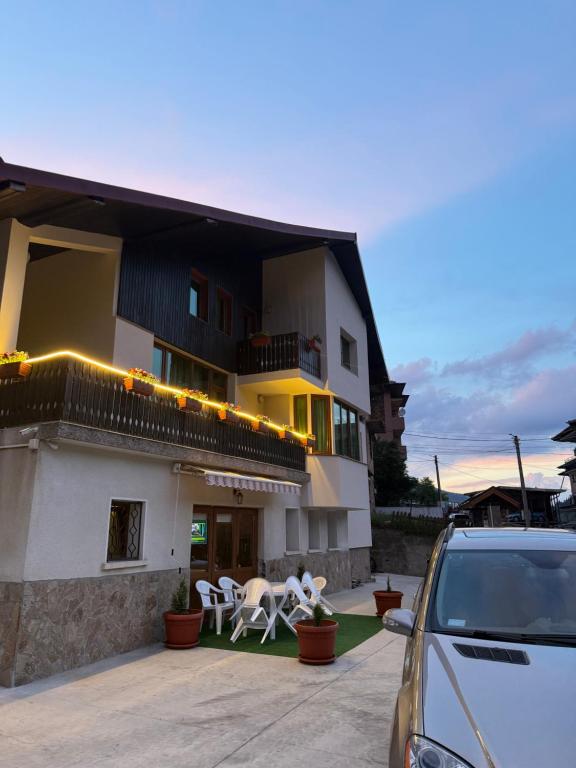 a car parked in front of a building at Guest House Скиора in Chepelare