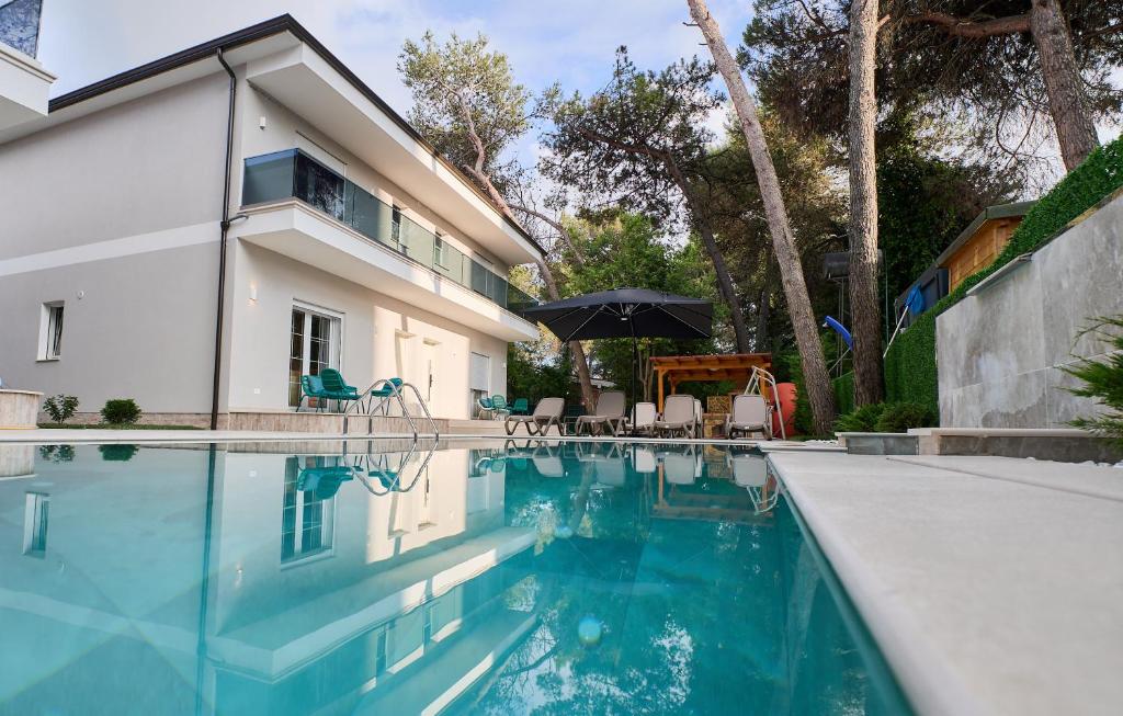 a swimming pool in front of a house at Blue Golem Durres Albania in Golem