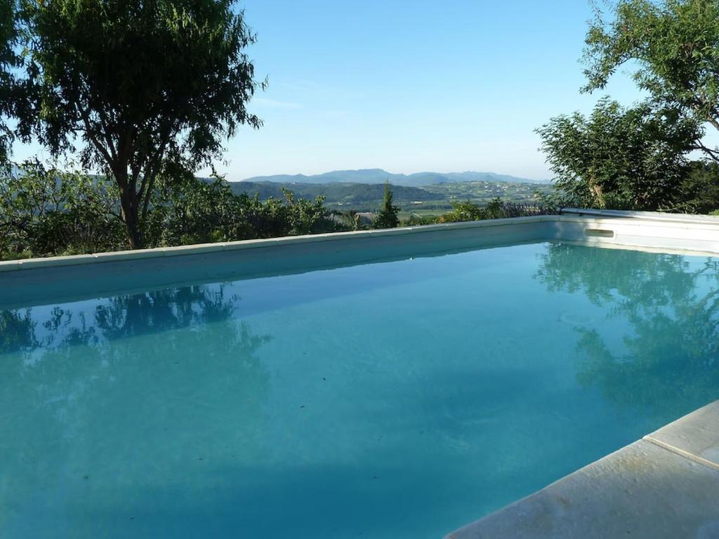 a swimming pool with a view of the mountains at La Roseraie des Côtes - Piscine in Vinsobres
