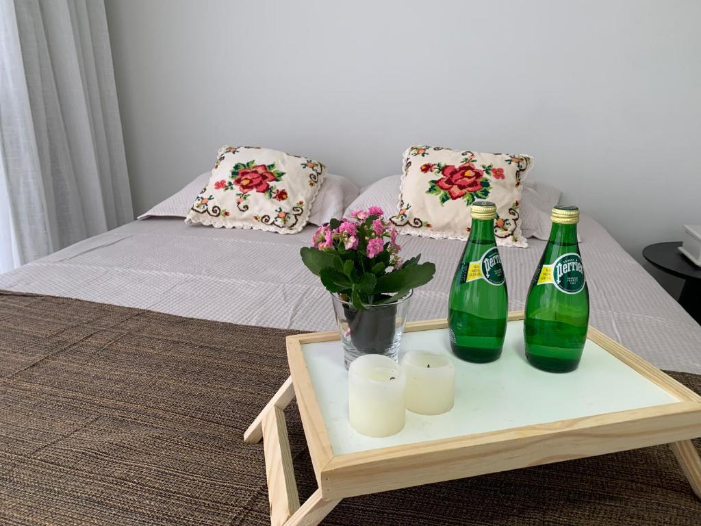 a table with two bottles and candles and flowers at Casa 161 in Diamantina