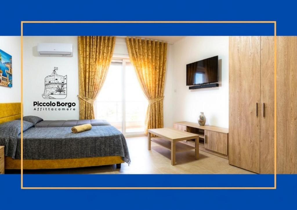 a bedroom with a bed and a tv and a cabinet at Piccolo Borgo Affittacamere BIKE FRIENDLY in Taranto