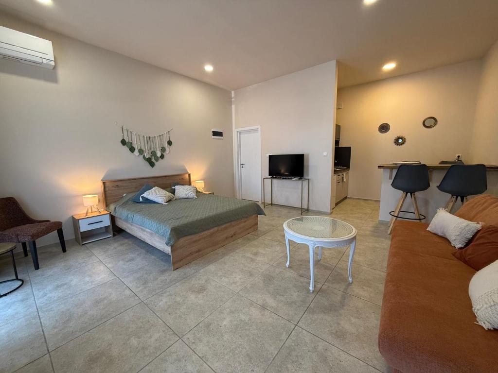 a bedroom with a bed and a living room at NM Residence 2 in Shkorpilovtsi